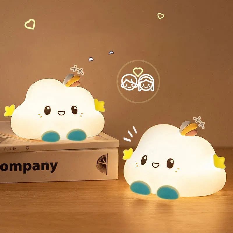 Two cloud-shaped LED night lights with faces, rainbow accents, and blue bases