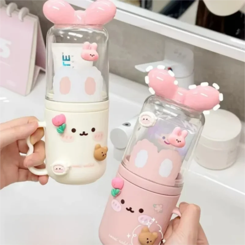 Cute toothbrush holder set with pink and cream containers, clear lids, bunny face graphics