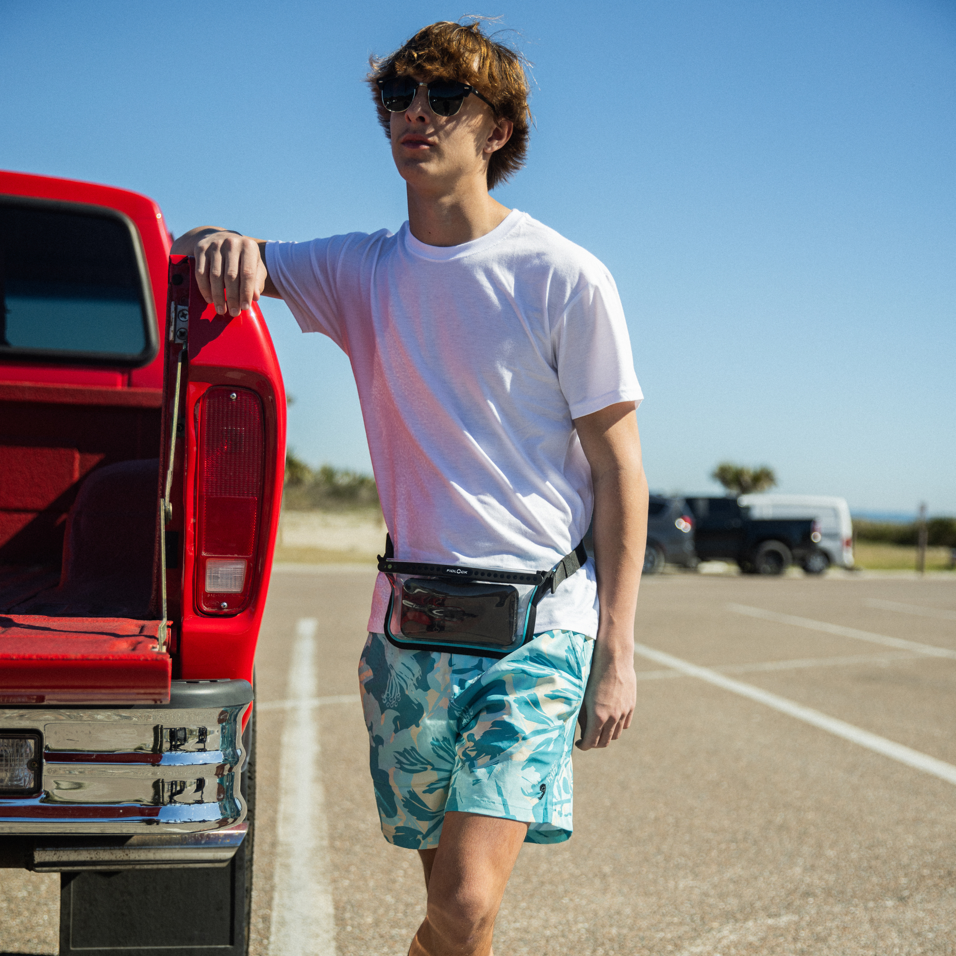 Waterproof fanny pack dry bag worn at waist, clear front window pocket with blue trim.