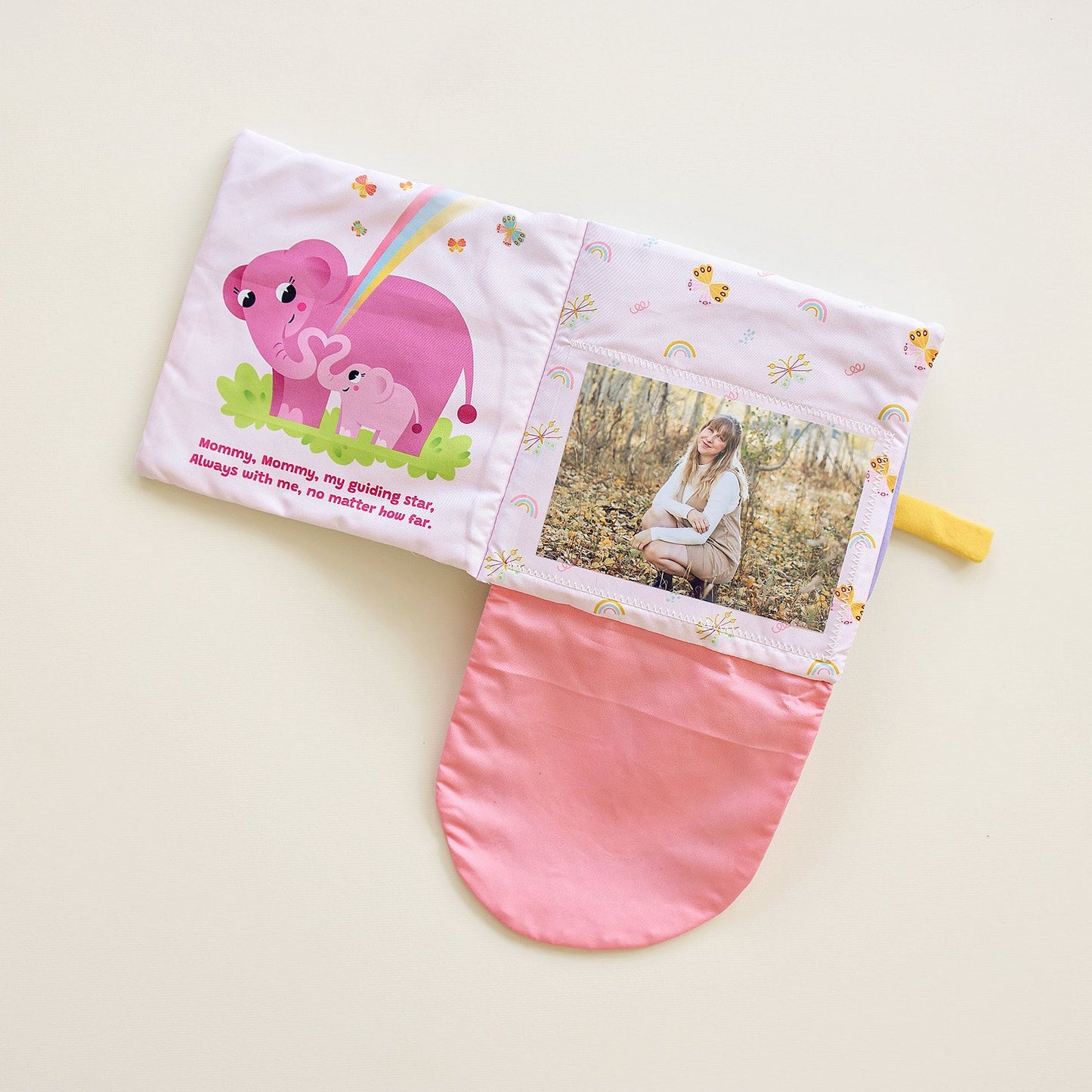 Fabric storybook with pink panel, cartoon animals, and a windowed photo pocket.