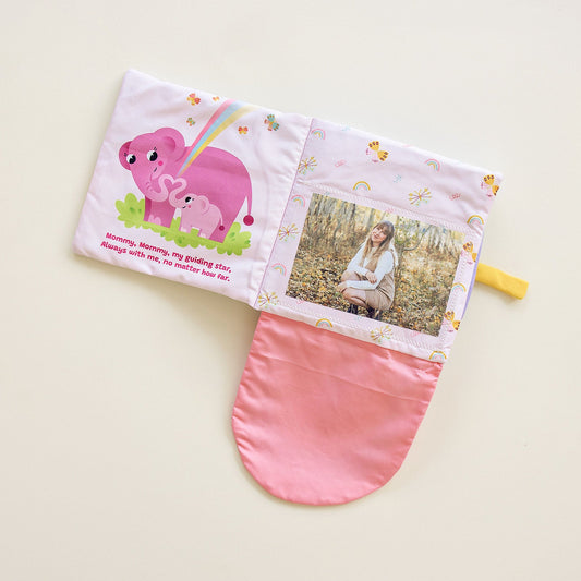 Fabric storybook with pink panel, cartoon animals, and a windowed photo pocket.