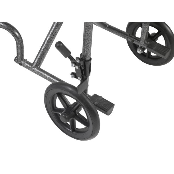 Detail of black wheelchair front caster wheels, footrest, and frame connection