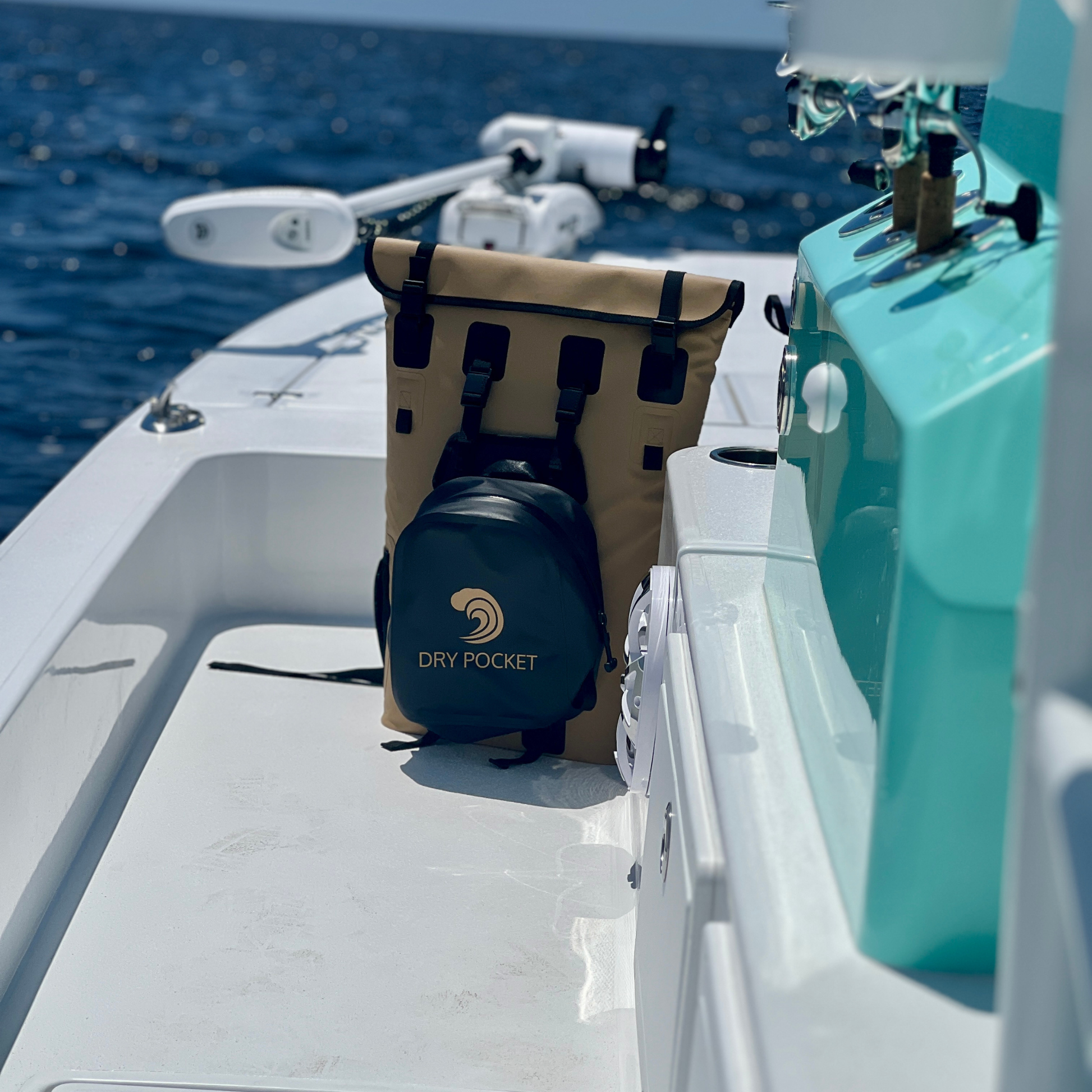 Waterproof floating backpack cooler on a boat deck with beige body, black straps, and DRY POCKET