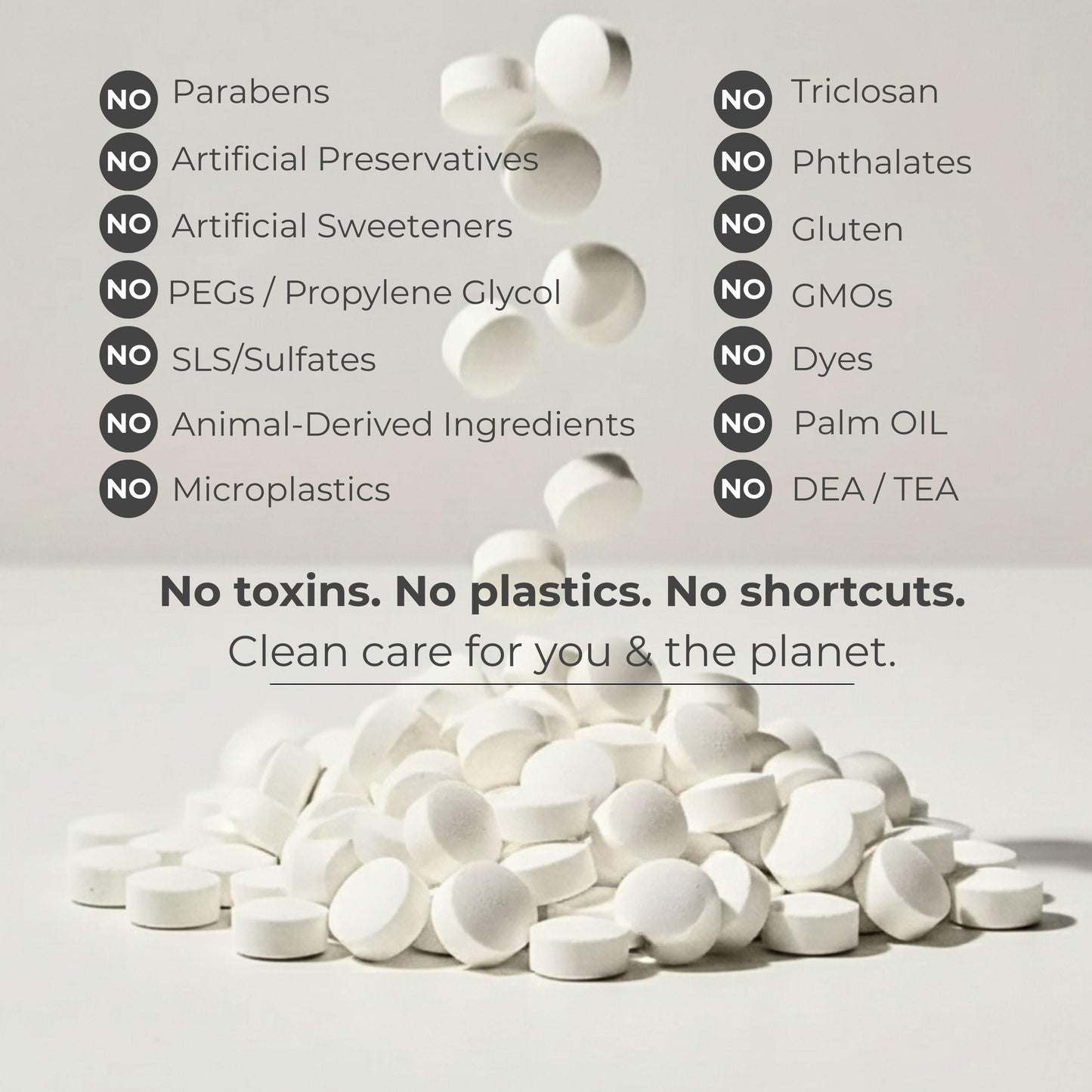 White fluoride toothpaste tablets scattered on a clean background