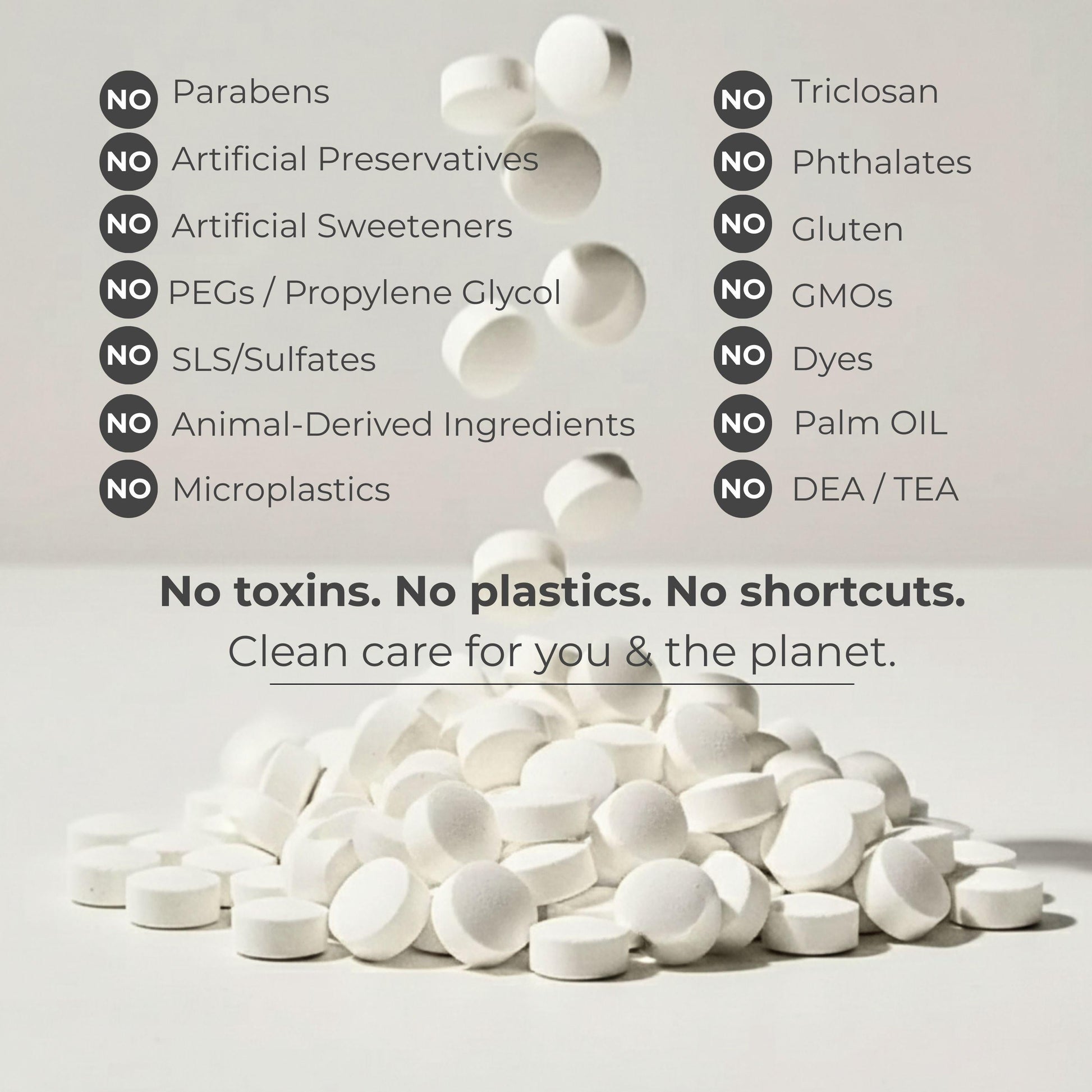 White fluoride toothpaste tablets scattered on a clean background