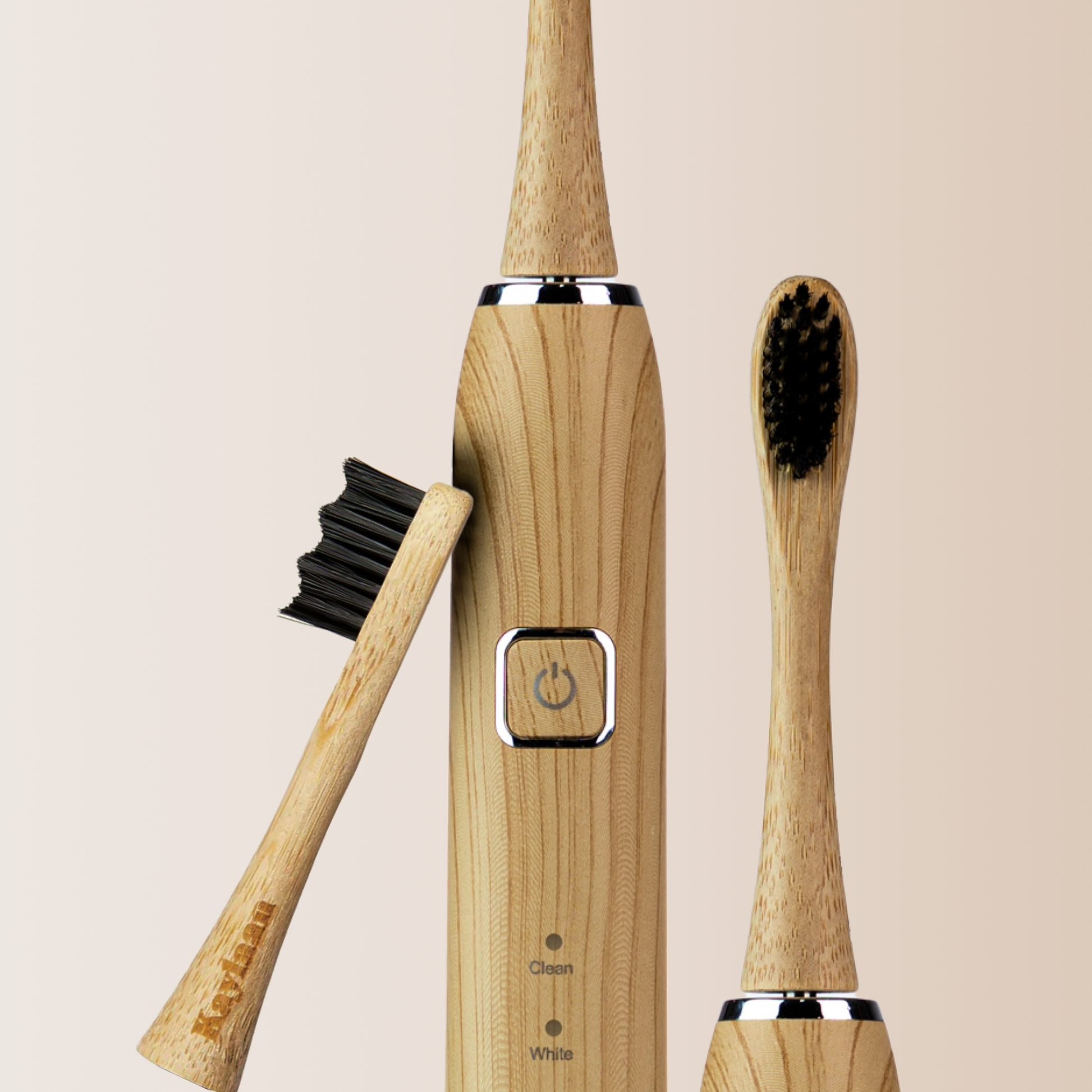 Bamboo electric toothbrush with black bristles and power button on wooden handle
