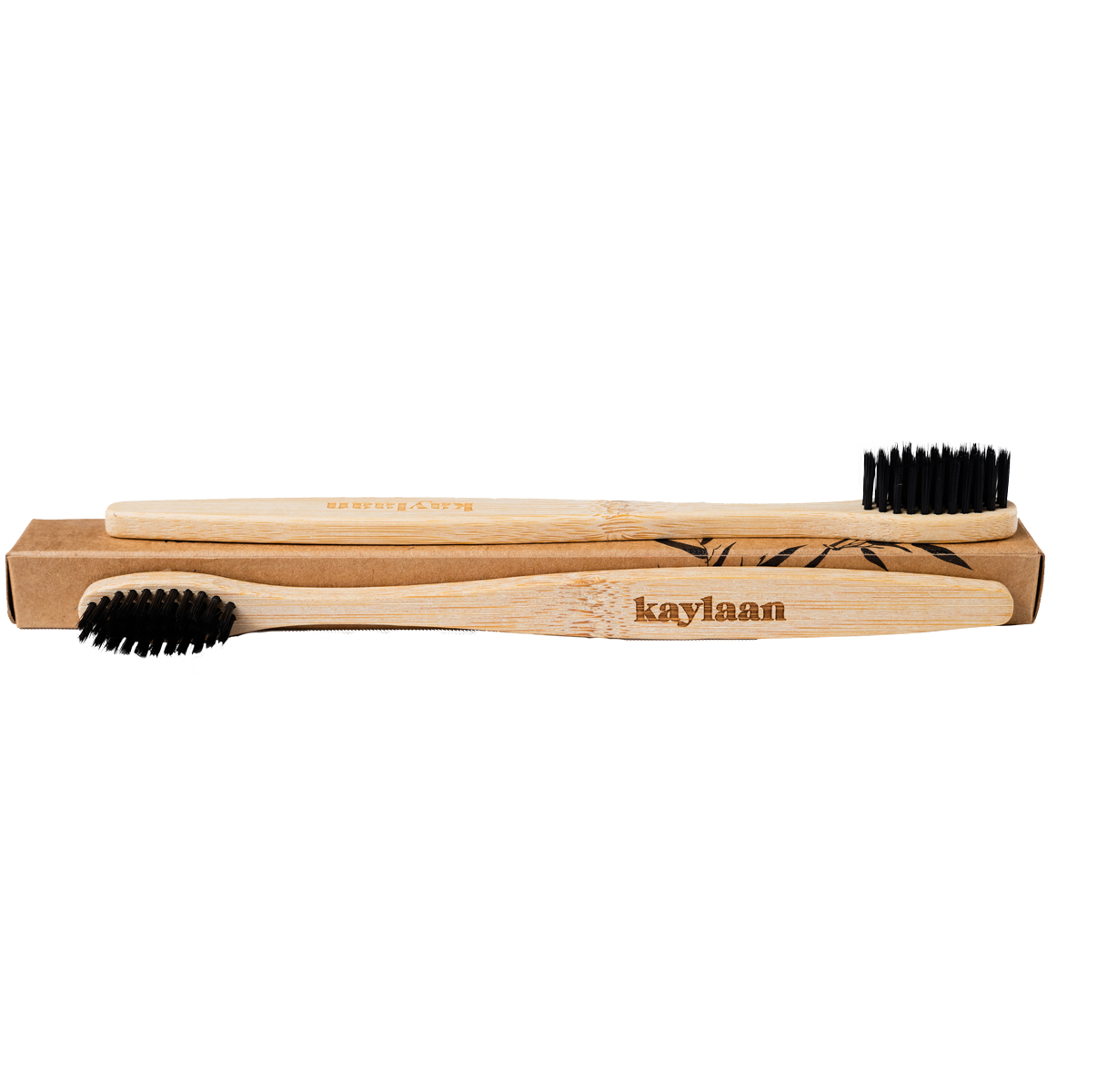 Kaylaan bamboo toothbrush with black bristles and light wood handle on open kraft tray