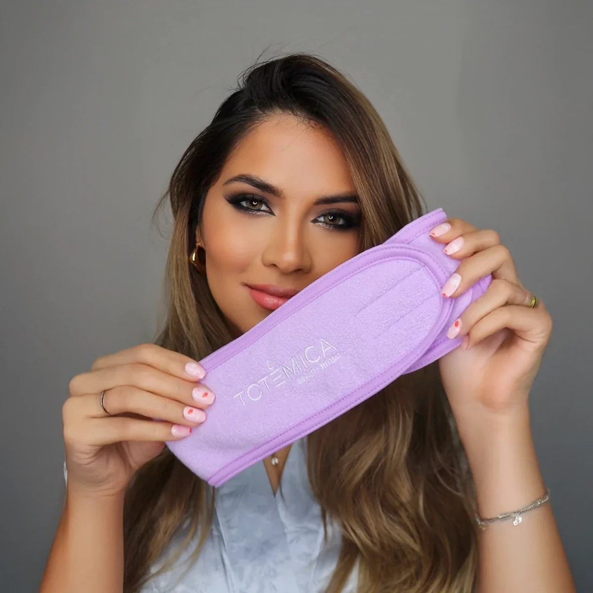 Purple terry spa headband with Totemica logo and adjustable fit