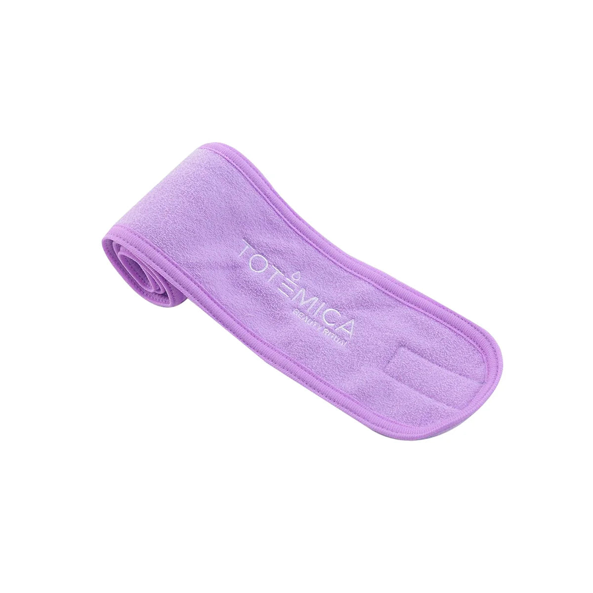 Purple terry spa headband with Totemica logo, rolled side