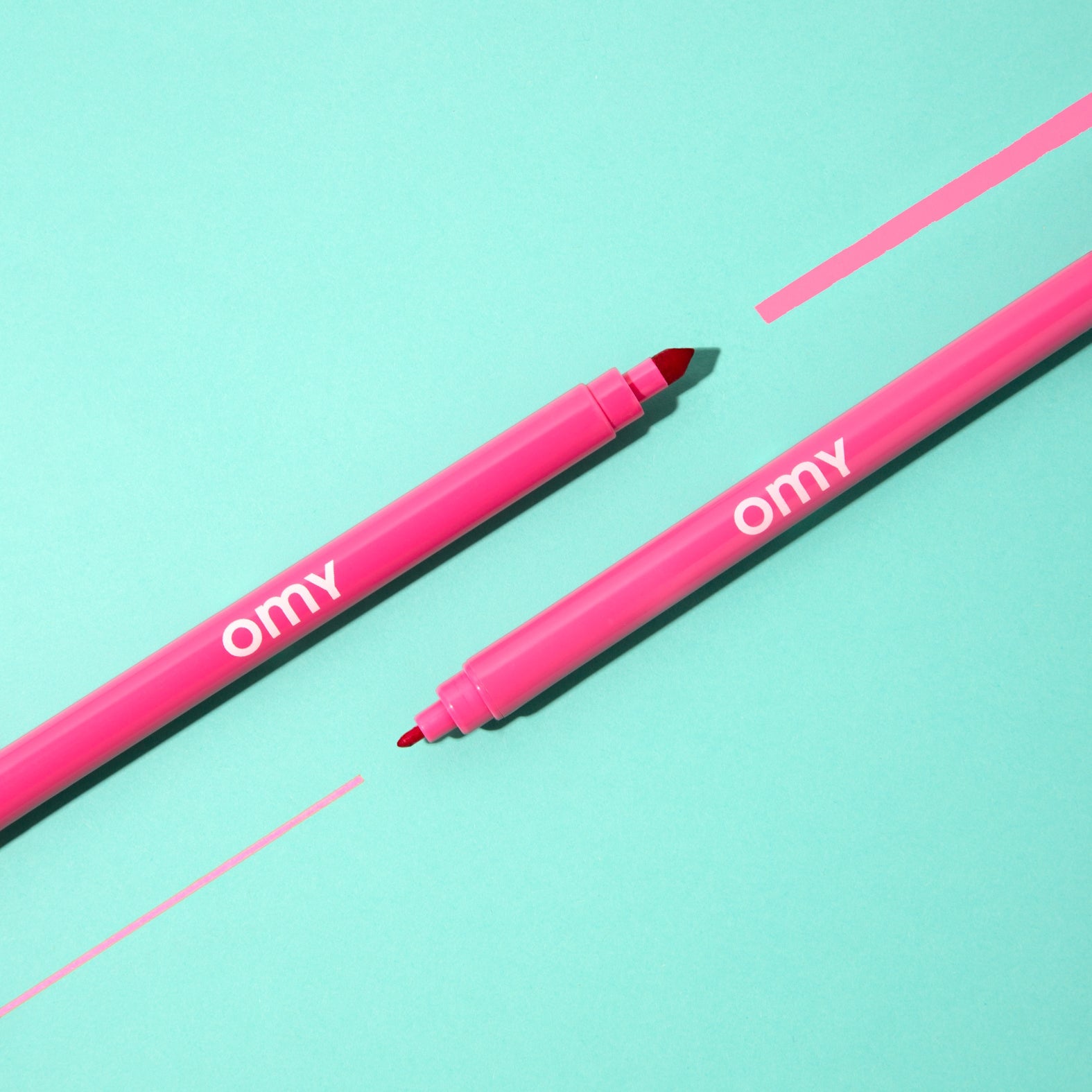 Two pink ultra-washable marker pens with black chisel tips
