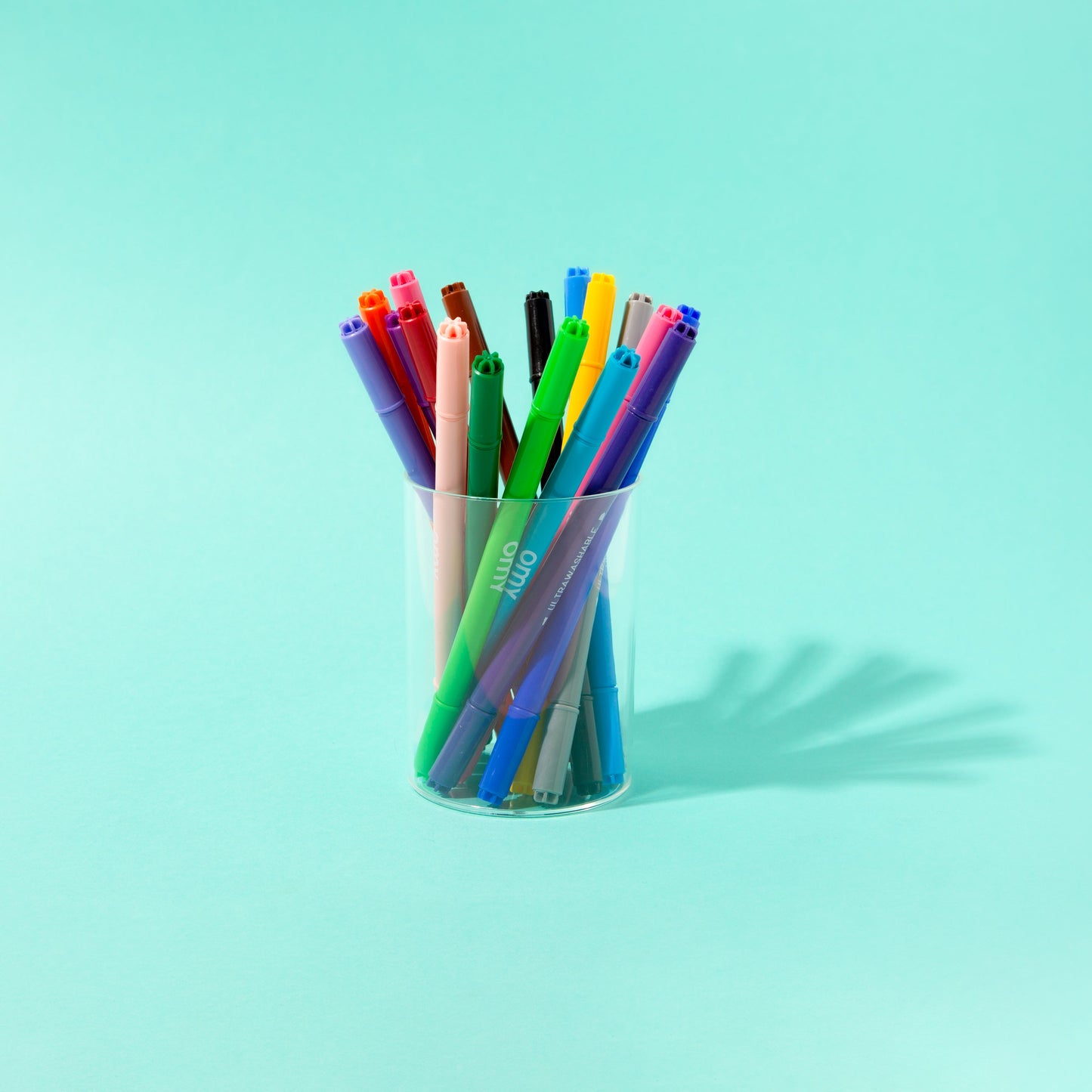 Cup holding assorted bright and pastel ultra-washable marker pens