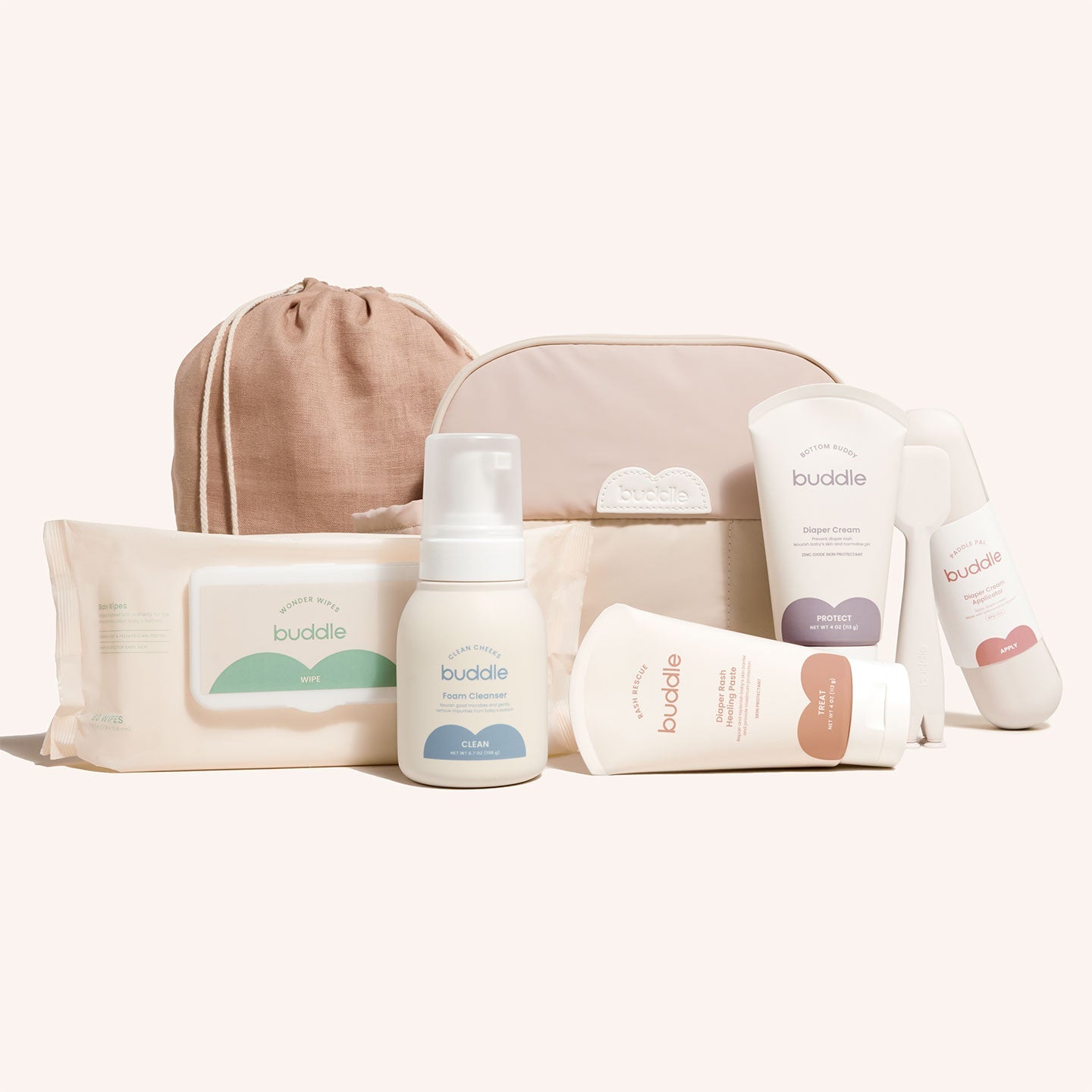 Diaper skincare kit with beige toiletry bag, cleanser pump, rash cream, wipes, and bottles