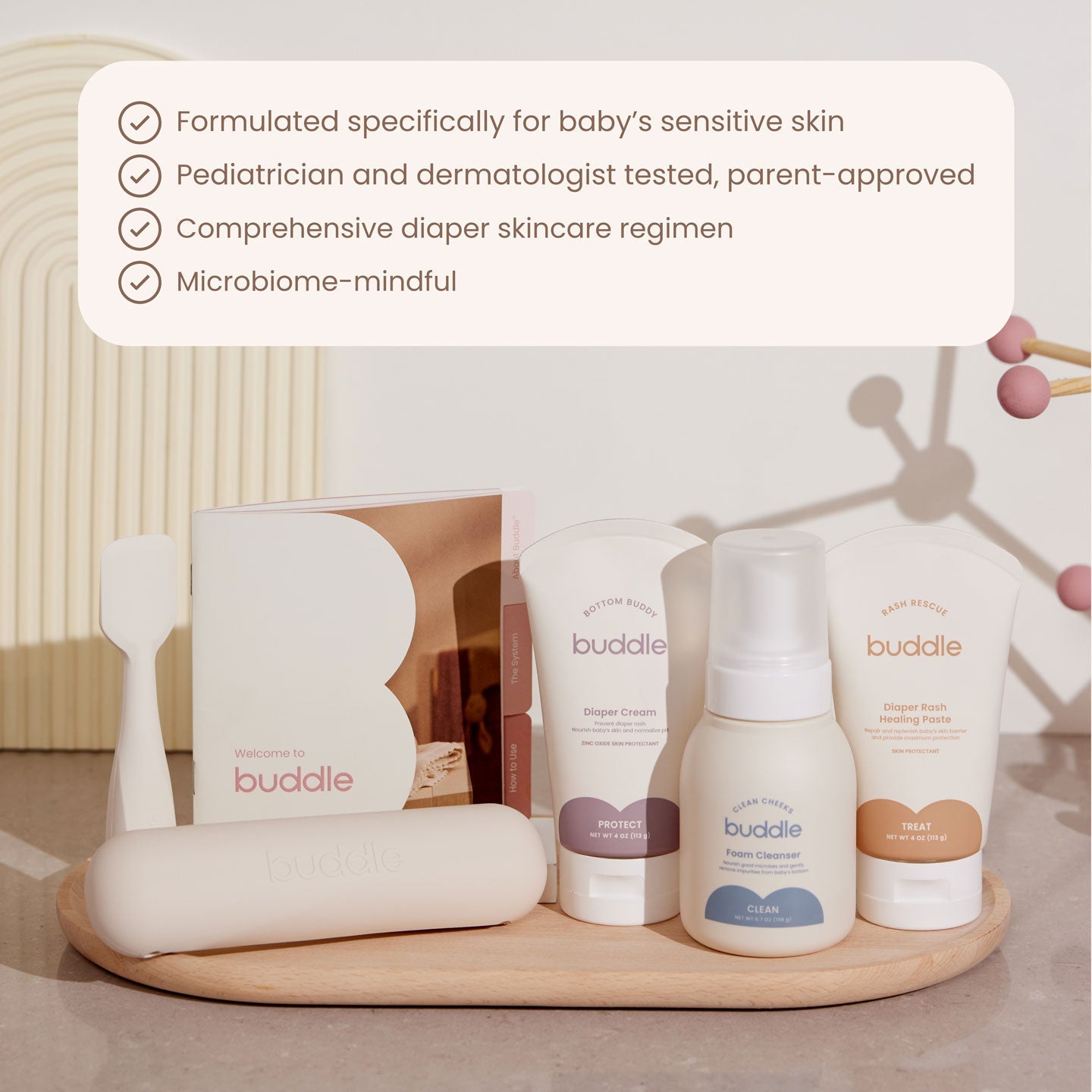 Diaper skincare kit with skincare bottles and cream tubes on tray, plus wipes and applicator