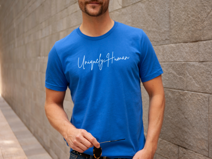 Blue crew-neck T-shirt with white script chest logo, short sleeves