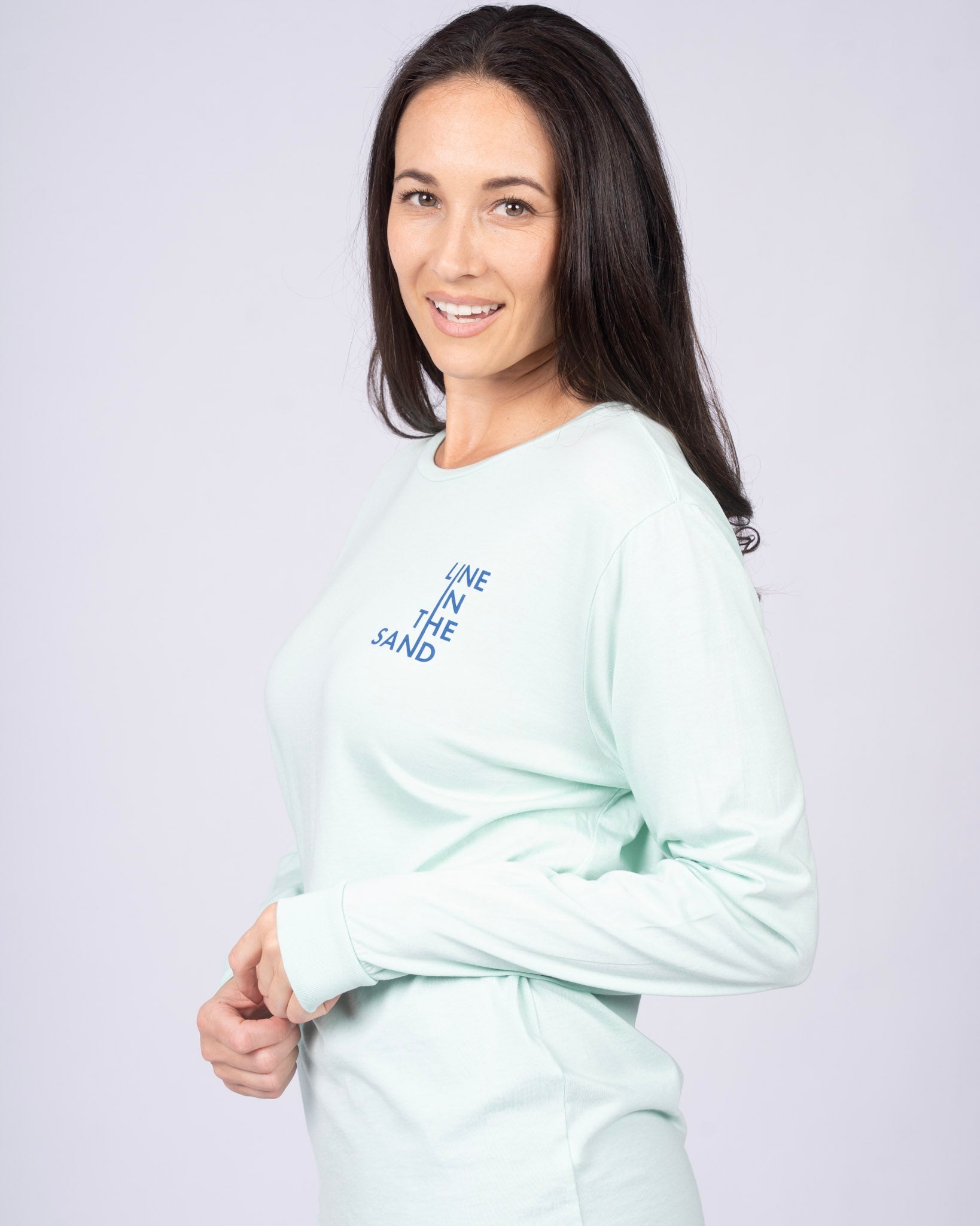 Mint unisex long-sleeve T-shirt with blue "Line in the Sand" logo on chest
