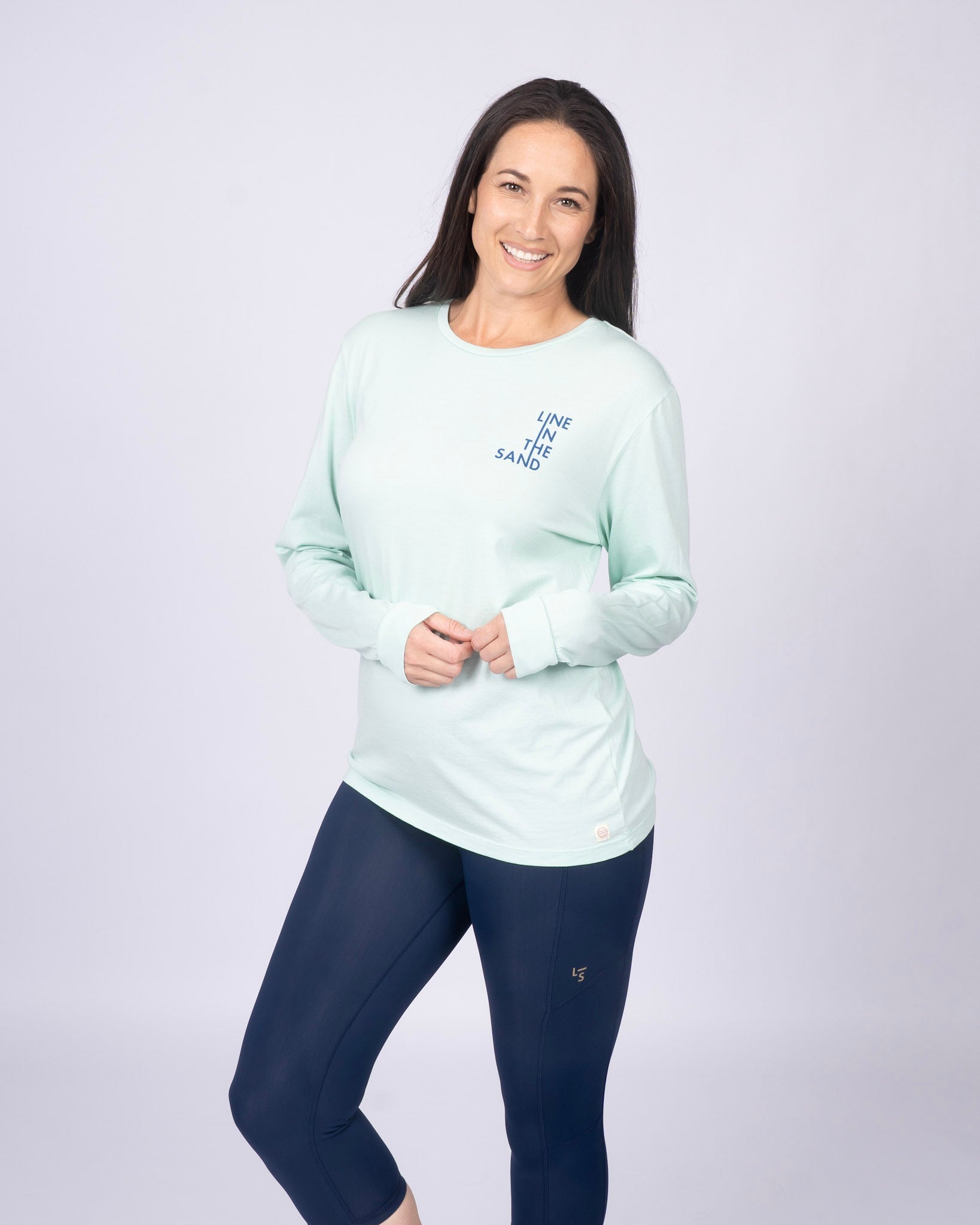 Mint unisex long-sleeve T-shirt with blue "Line in the Sand" chest graphic