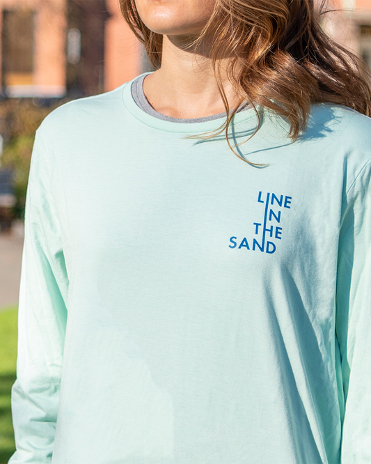 Mint unisex long-sleeve T-shirt with blue "Line in the Sand" text