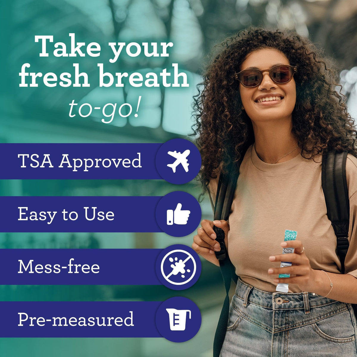 Oil pulling travel sachets held in hand by smiling woman with backpack