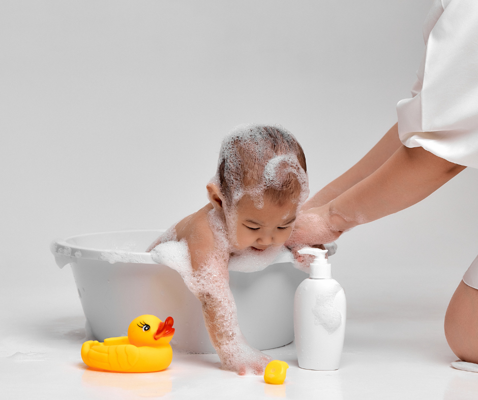 Baby bath sponge and bristle brush used during bathing, blue sponge in hand