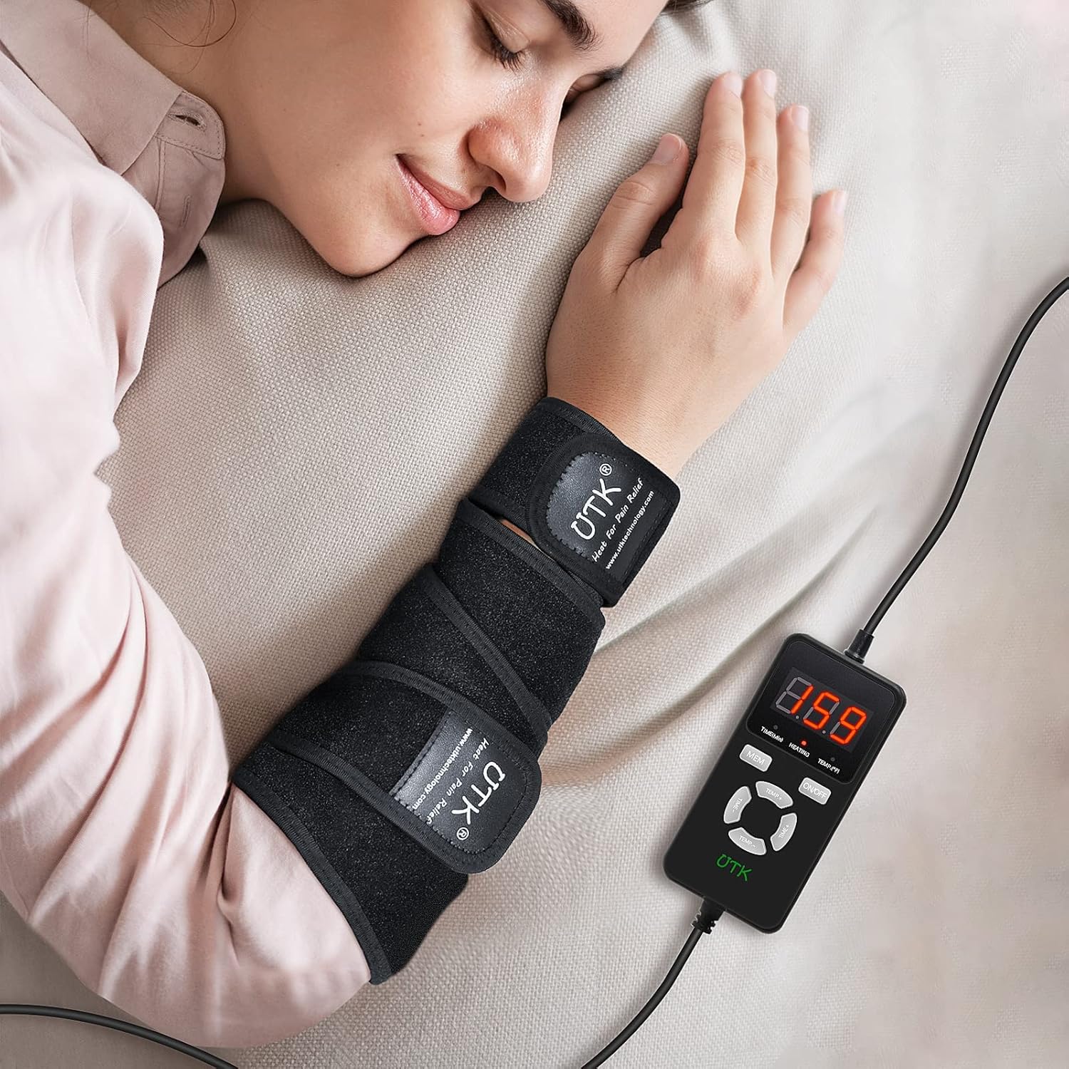 Far infrared heating pad wrap on forearm with black straps and small digital controller