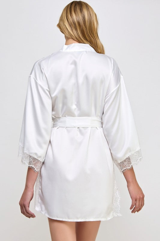 White satin robe from back view with tied waist belt and lace-trimmed sleeve cuffs