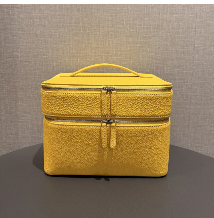 Yellow leather-look jewelry storage tote with double zippers and top handle