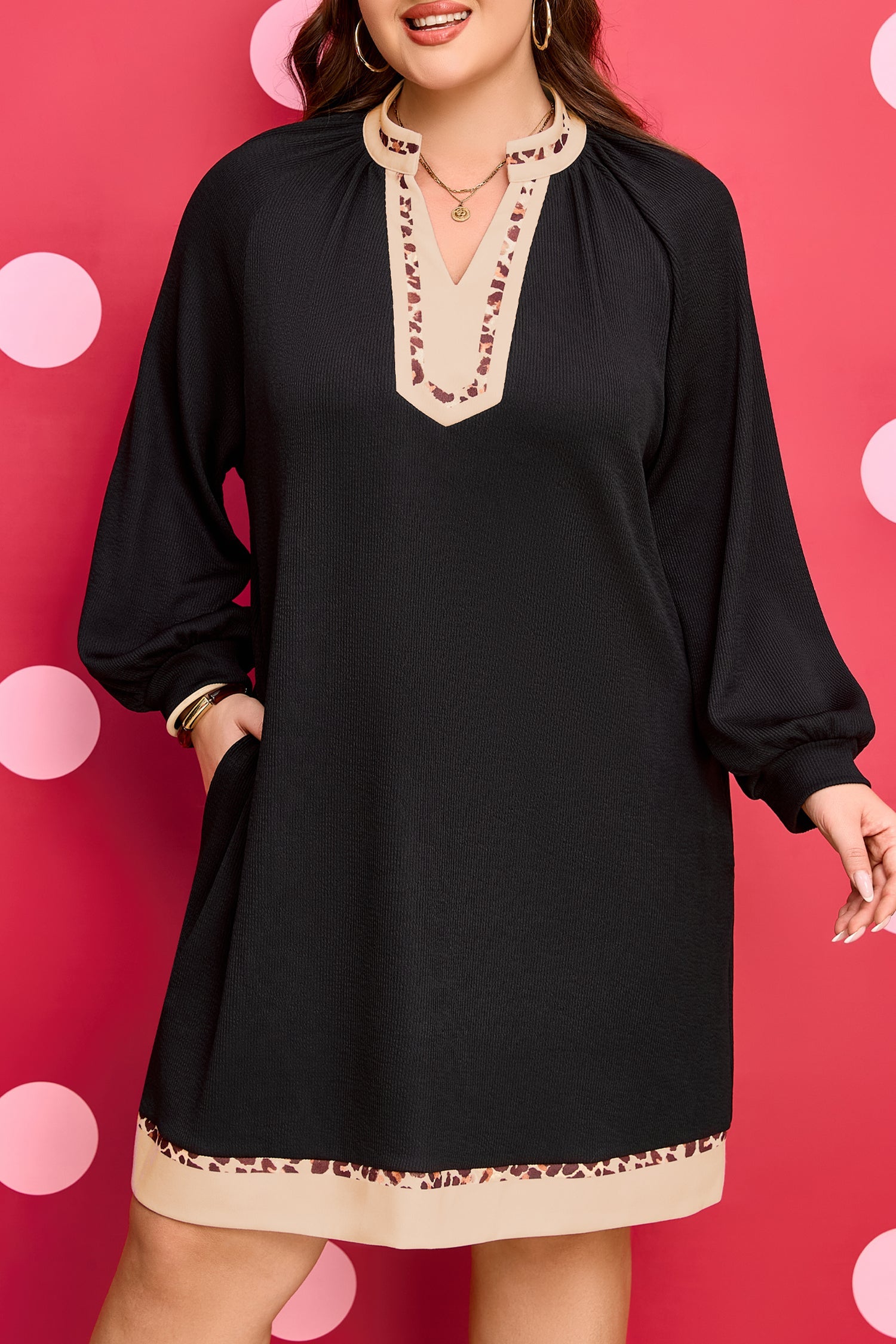 Black PLUS dress front view with V-neck embroidery and cream contrast hem trim