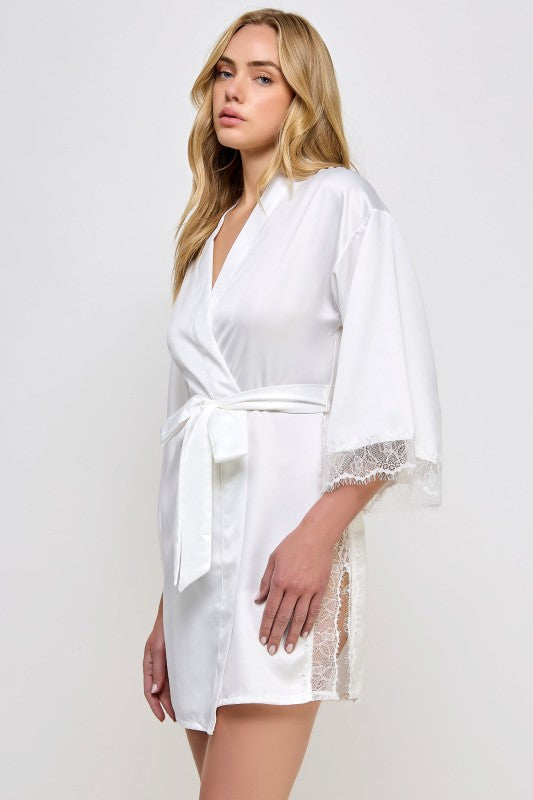 White satin robe with V-neck and tied waist belt, lace-trimmed hem and sleeve cuffs