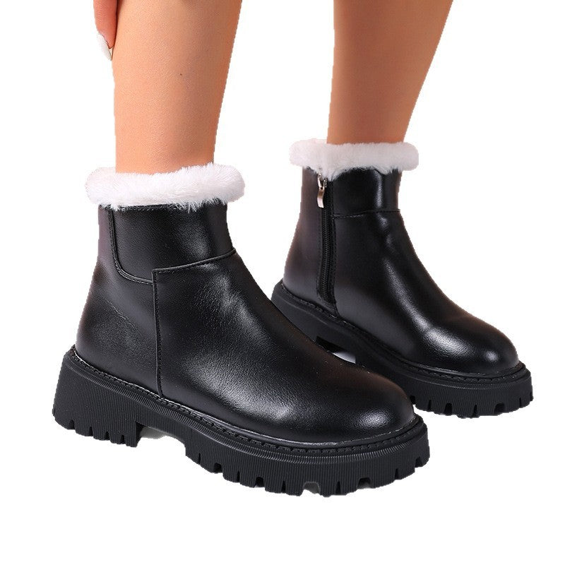 Black leather ankle boots with white faux-fur cuff, side zipper, and lug sole
