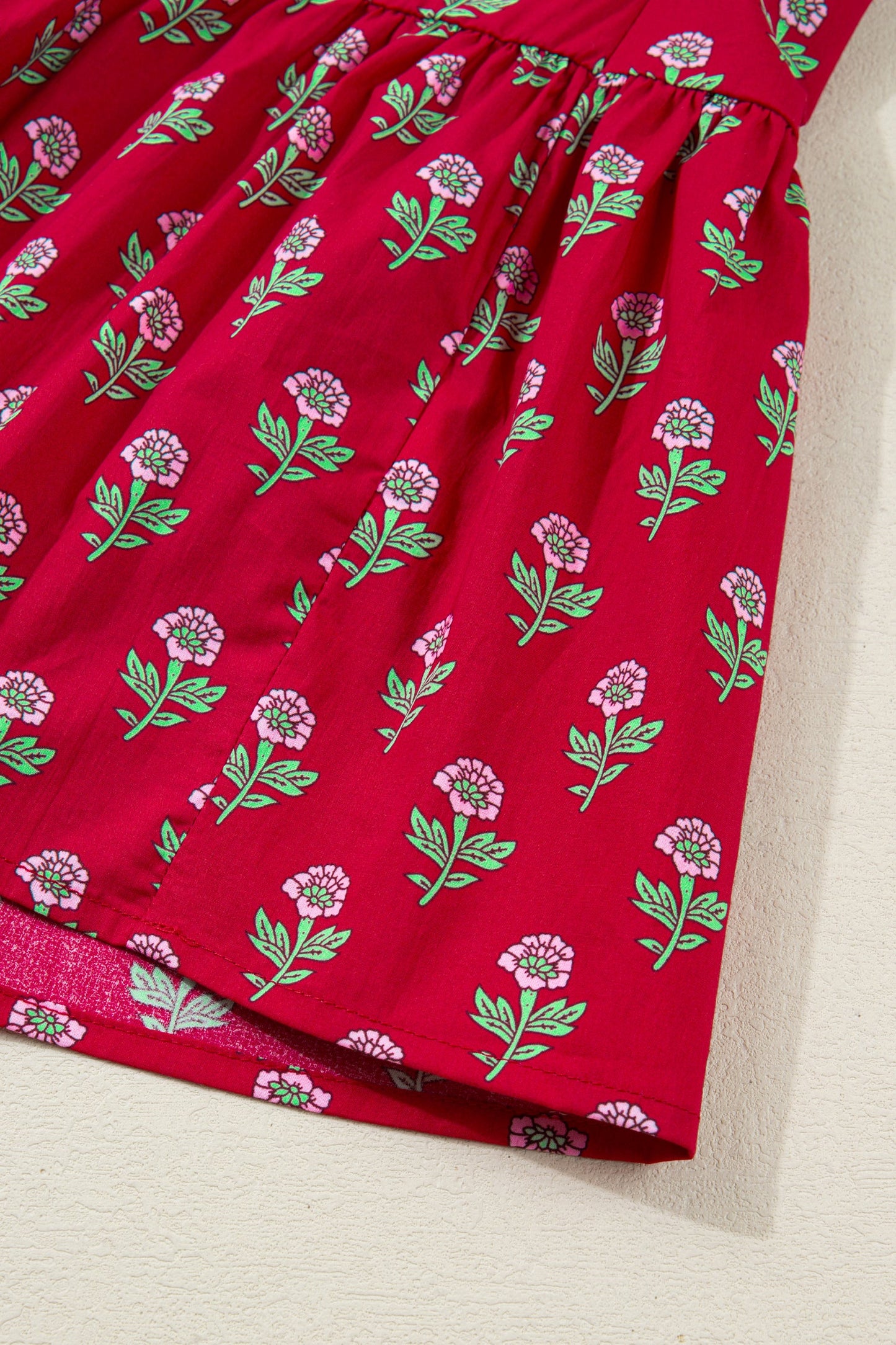 Red mini dress skirt with green stems and pink flower pattern