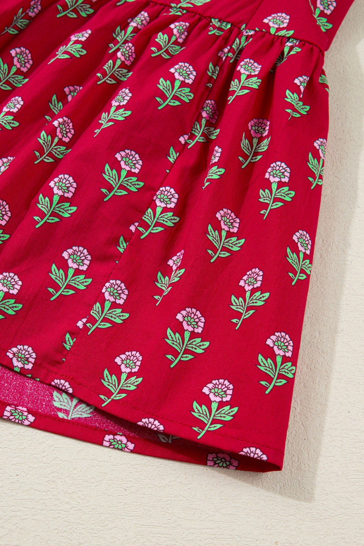 Red mini dress skirt with green stems and pink flower pattern