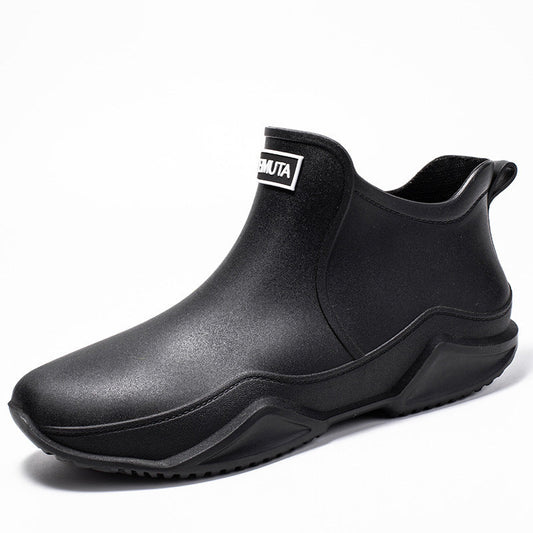 Black low-top rubber rain boot with side gore and thick tread outsole