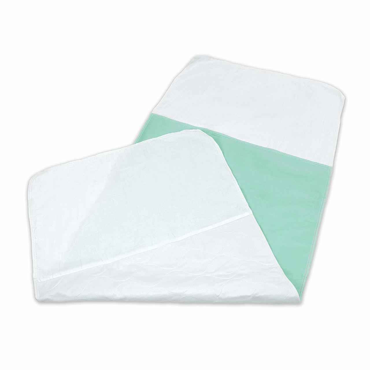 Washable reusable underpad with white outer layer and mint underside, folded