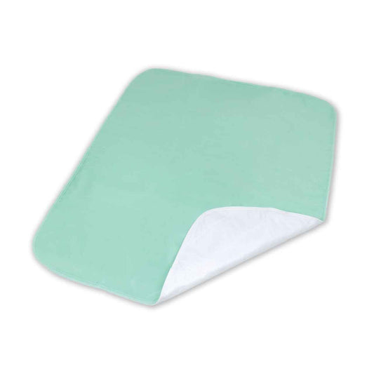 Mint-green washable reusable underpad with white backing, folded corner view