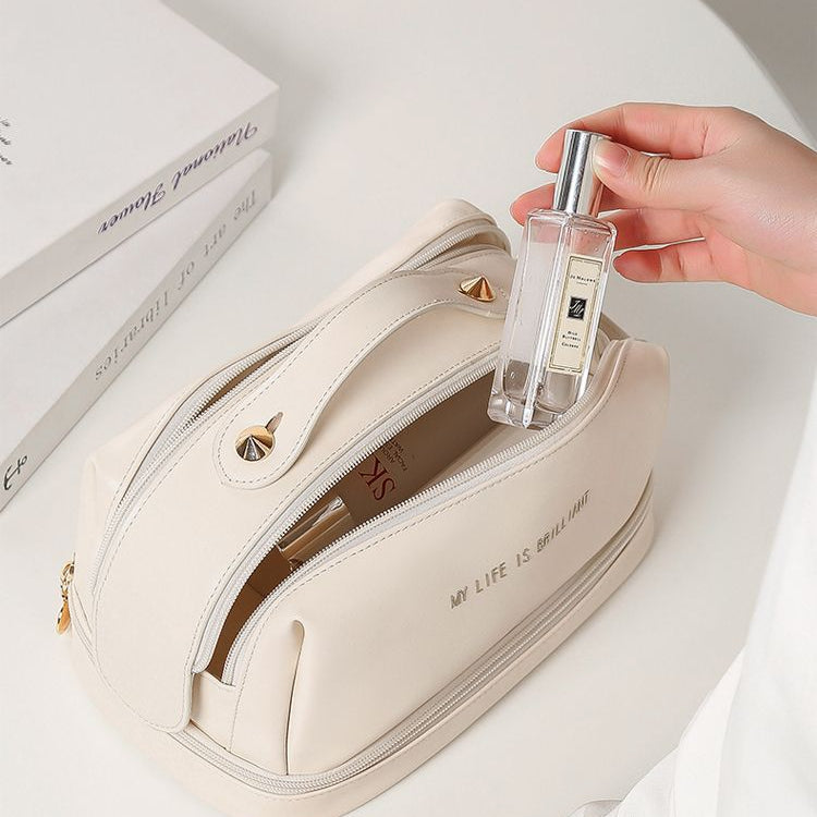 Off-white double-zip makeup bag open, showing interior compartments and zipper track