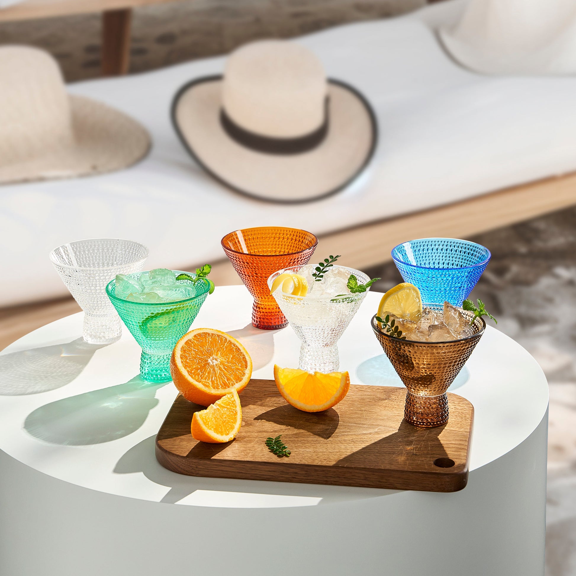 Hobnail acrylic martini glasses in orange, blue, green, and clear, on a tray