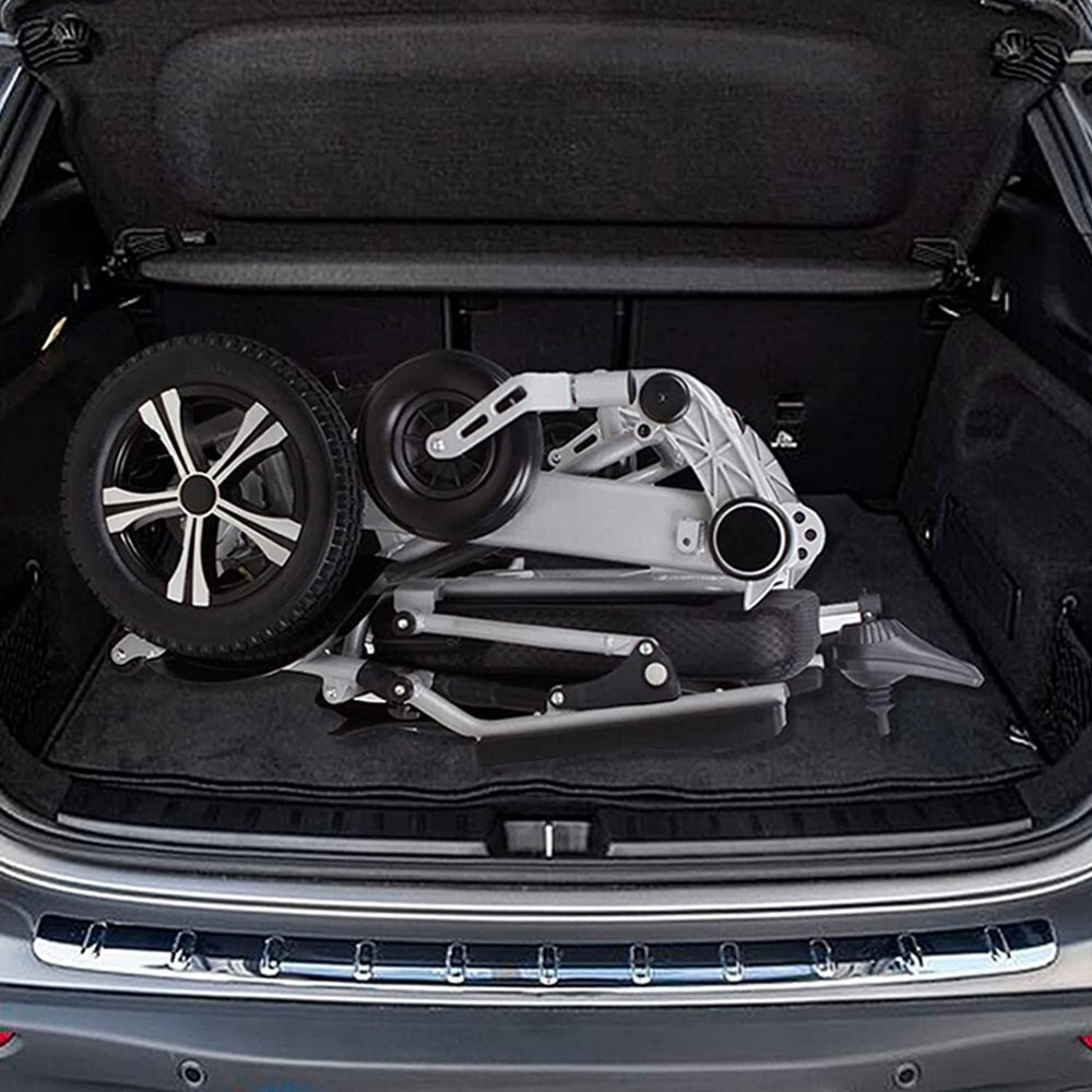 Folded electric wheelchair in trunk space: black seat, silver frame, wheel assemblies