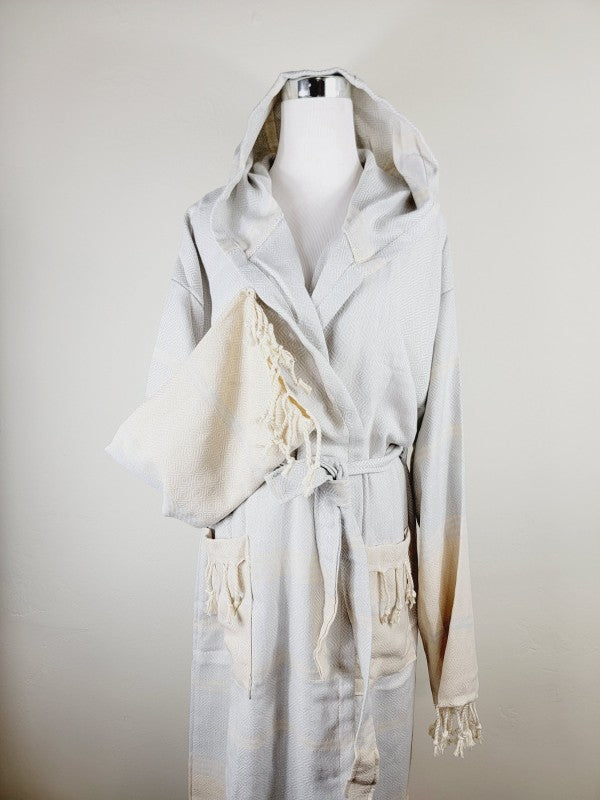 Off-white hooded robe with belt, patch pockets, and tassel-trim cuffs