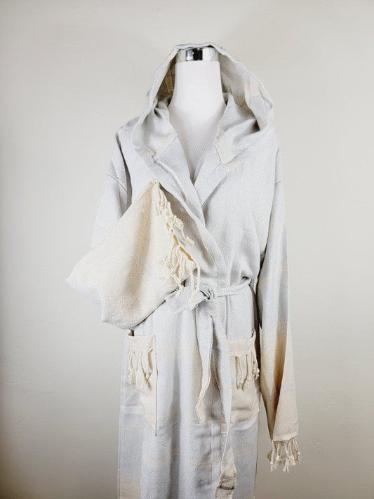Off-white hooded robe with belt, patch pockets, and tassel-trim cuffs