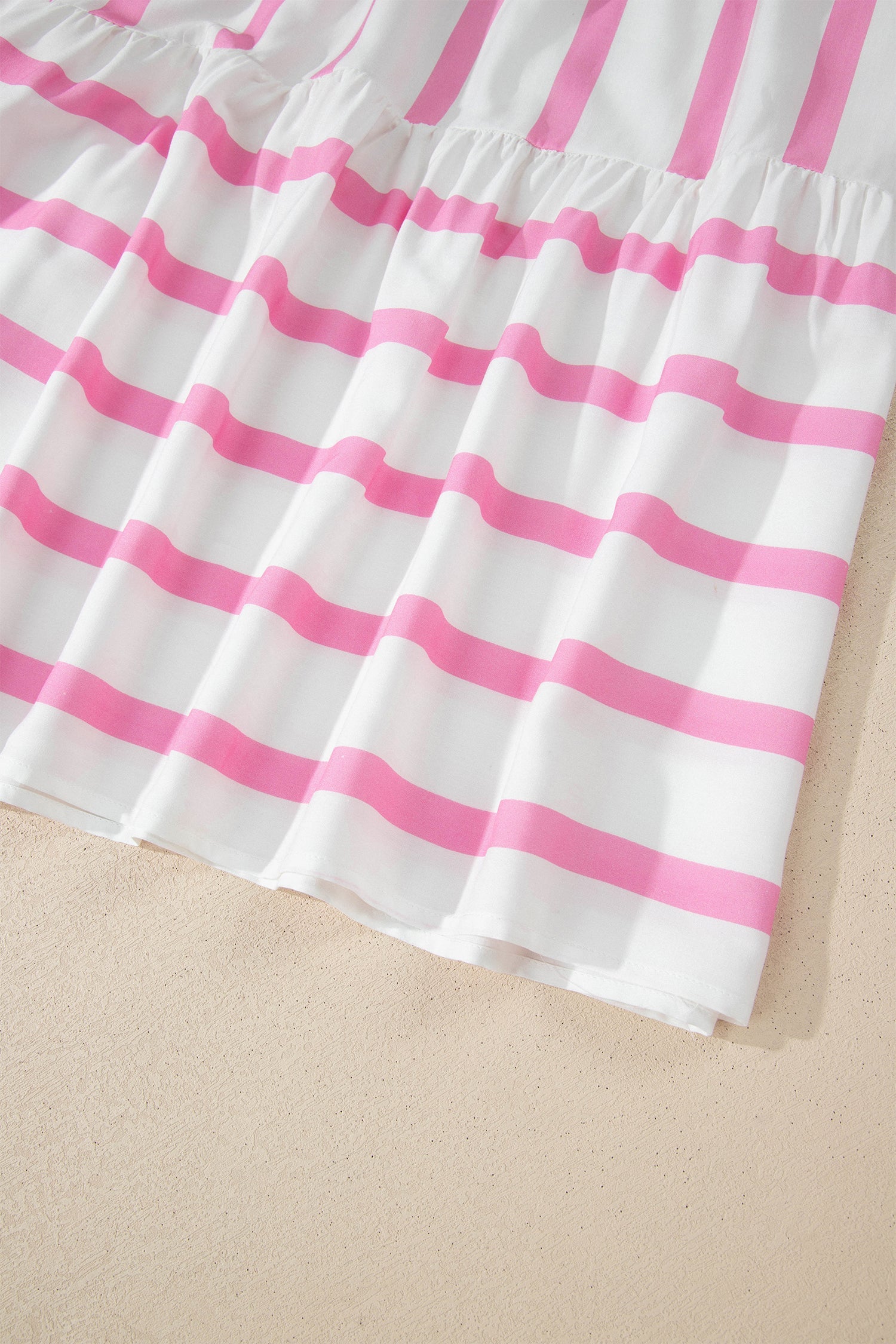 Pink-and-white striped gathered hem tier on a maxi dress