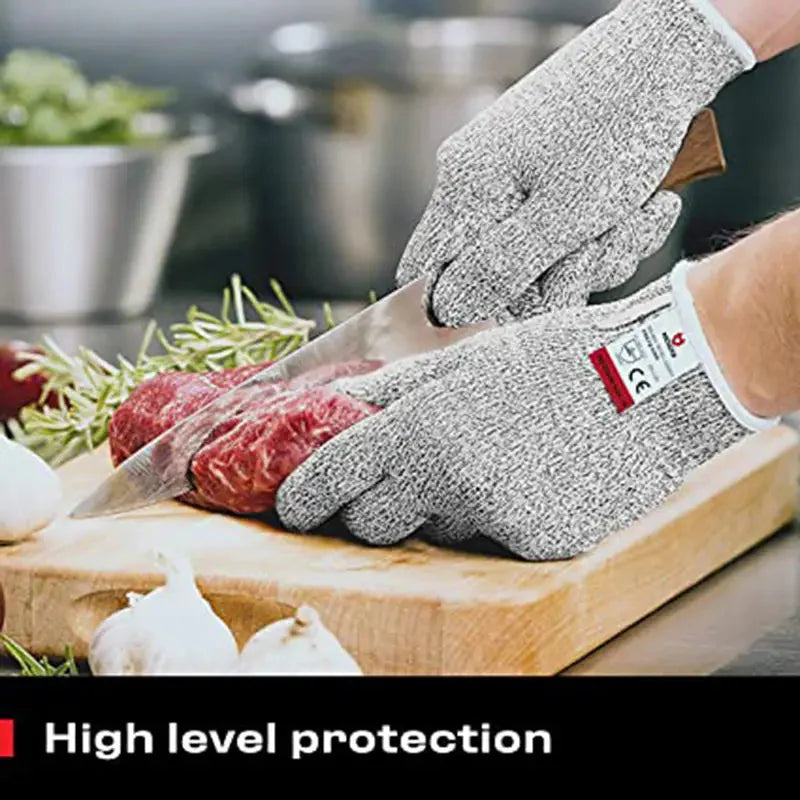 Grey anti-cut gloves worn while cutting food, knit palms and white wrist cuffs visible