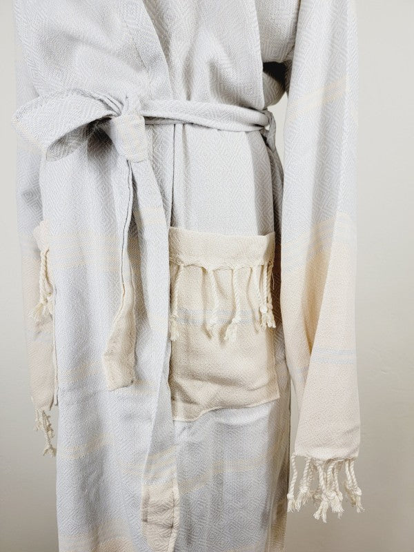 Light white robe waist tie with front pocket detail and fringed sleeve cuffs