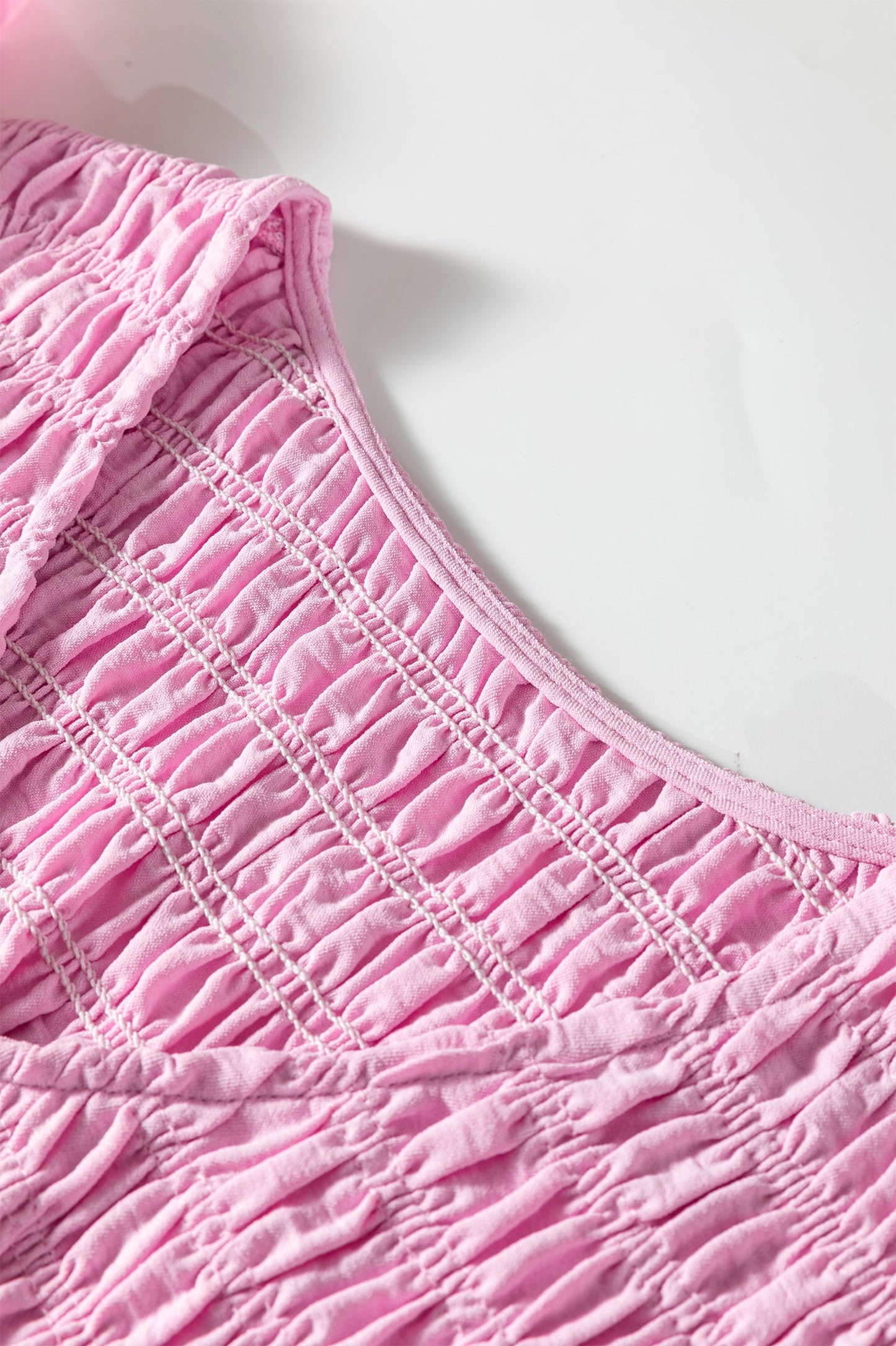 Pink V-neck smocked bodice panel with textured gathered tier stripes