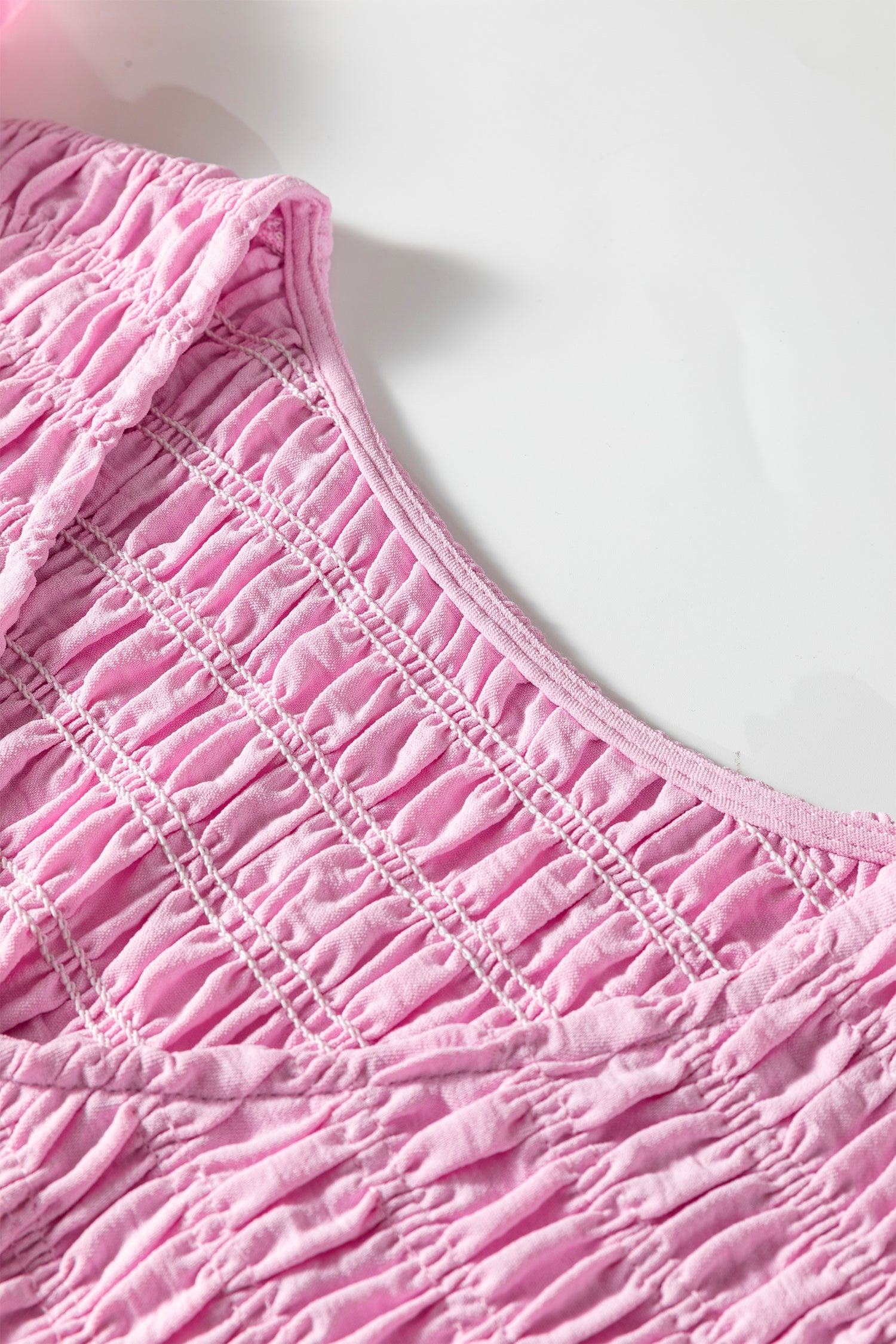 Pink V-neck smocked bodice panel with textured gathered tier stripes
