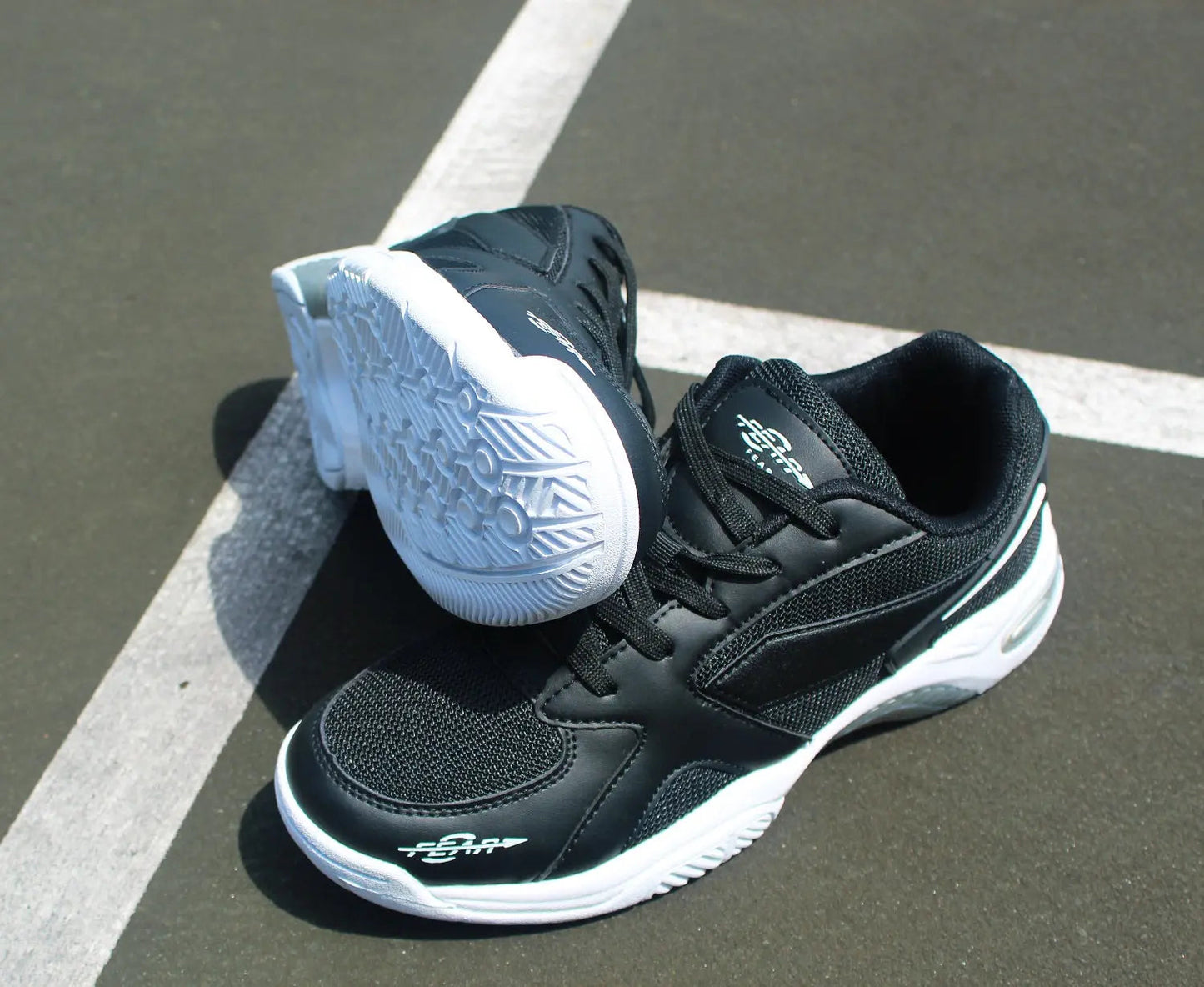 Men’s black walking shoes with white soles, shown from side and heel angle