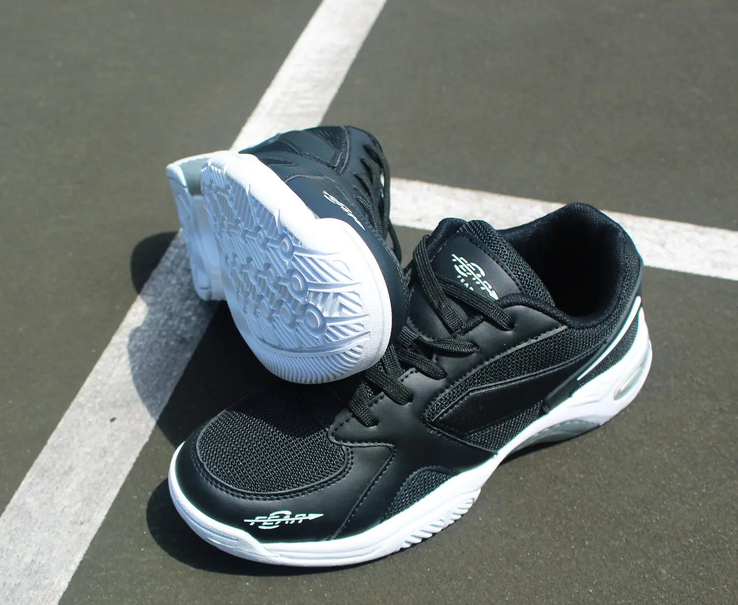 Men’s black walking shoes with white soles, shown from side and heel angle