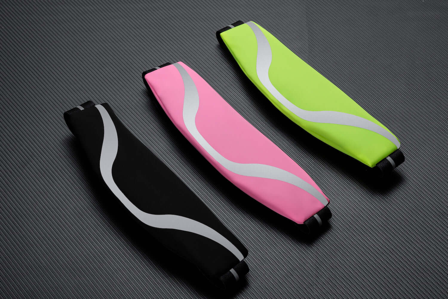 Water-resistant sport waist pack running belt set with pink and neon green reflective stripes.