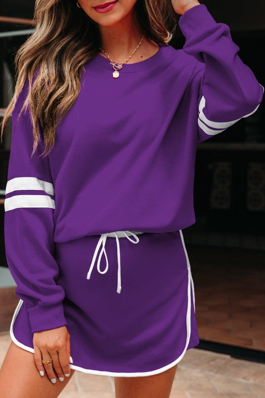 Purple pullover and mini skirt with white sleeve stripe cuffs and drawstring waist ties.