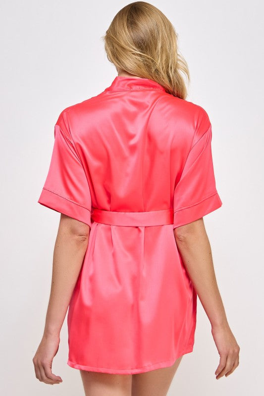 Back view of hot pink satin robe with tie belt and short sleeves