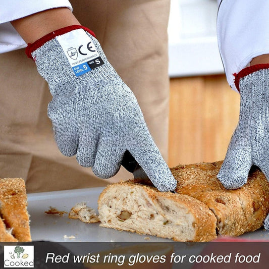Grey anti-cut kitchen gloves worn, textured knit and red cuff trim visible